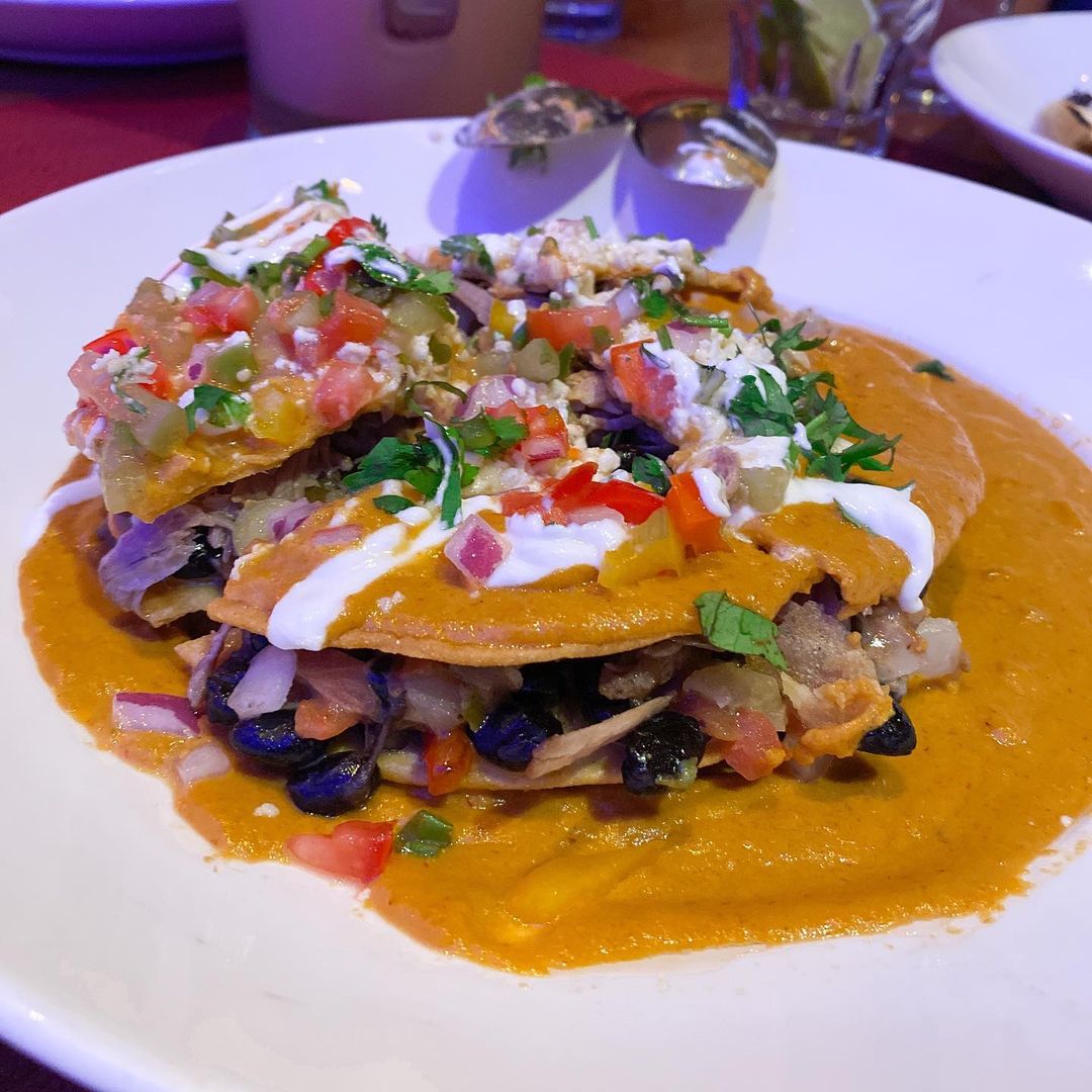 $12 ZARAPE DE NACHOS-Crispy corn tortillas layered with black beans, queso fresc…